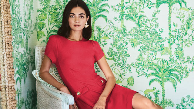 Women in red dress sitting on chair